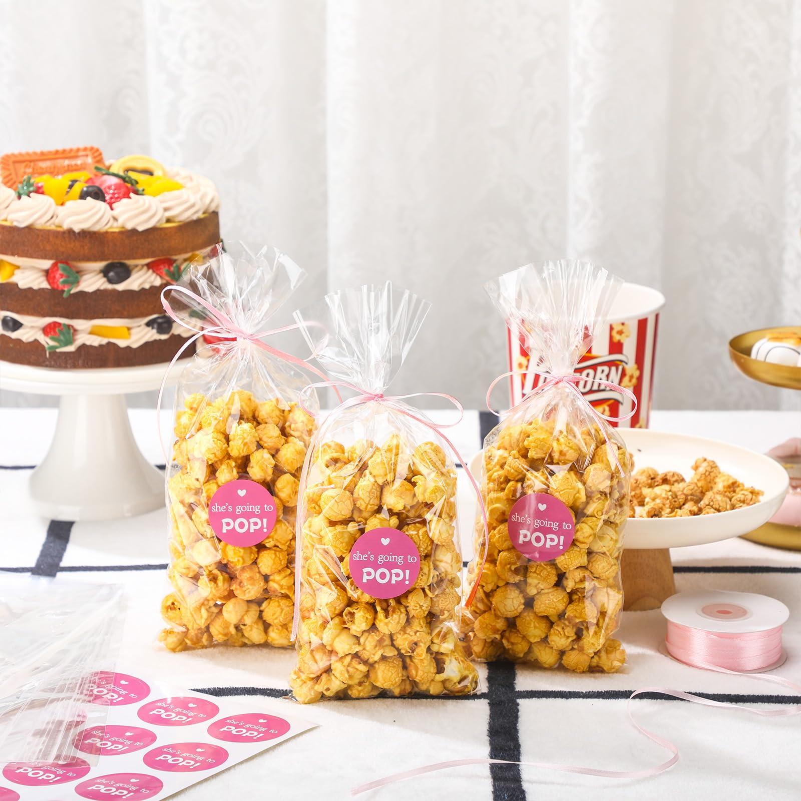 Menkxi Menkxi 100 Pack Clear Popcorn Bags Bulk 4.92 x 10.83 Inch Cellophane Treat Plastic Party Favors Bags with She Is Going to Pop Label and Ribbon for Gift Wrapping, Food Storage, Baby Shower Decor(Pink)